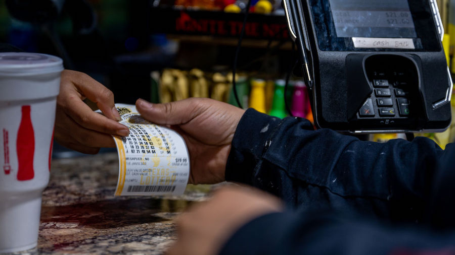 A customer purchases a lottery ticket at a CITGO gas station on January 10, 2023 in Austin, Texas. ...
