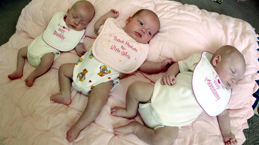 three babies on a pink blanket...