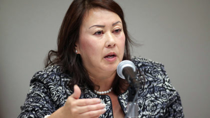 Karen Kwan speaks at a microphone