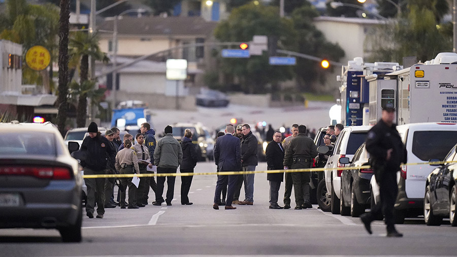 Law enforcement personnel gather outside a ballroom dance club in Monterey Park, Calif., Sunday, Ja...