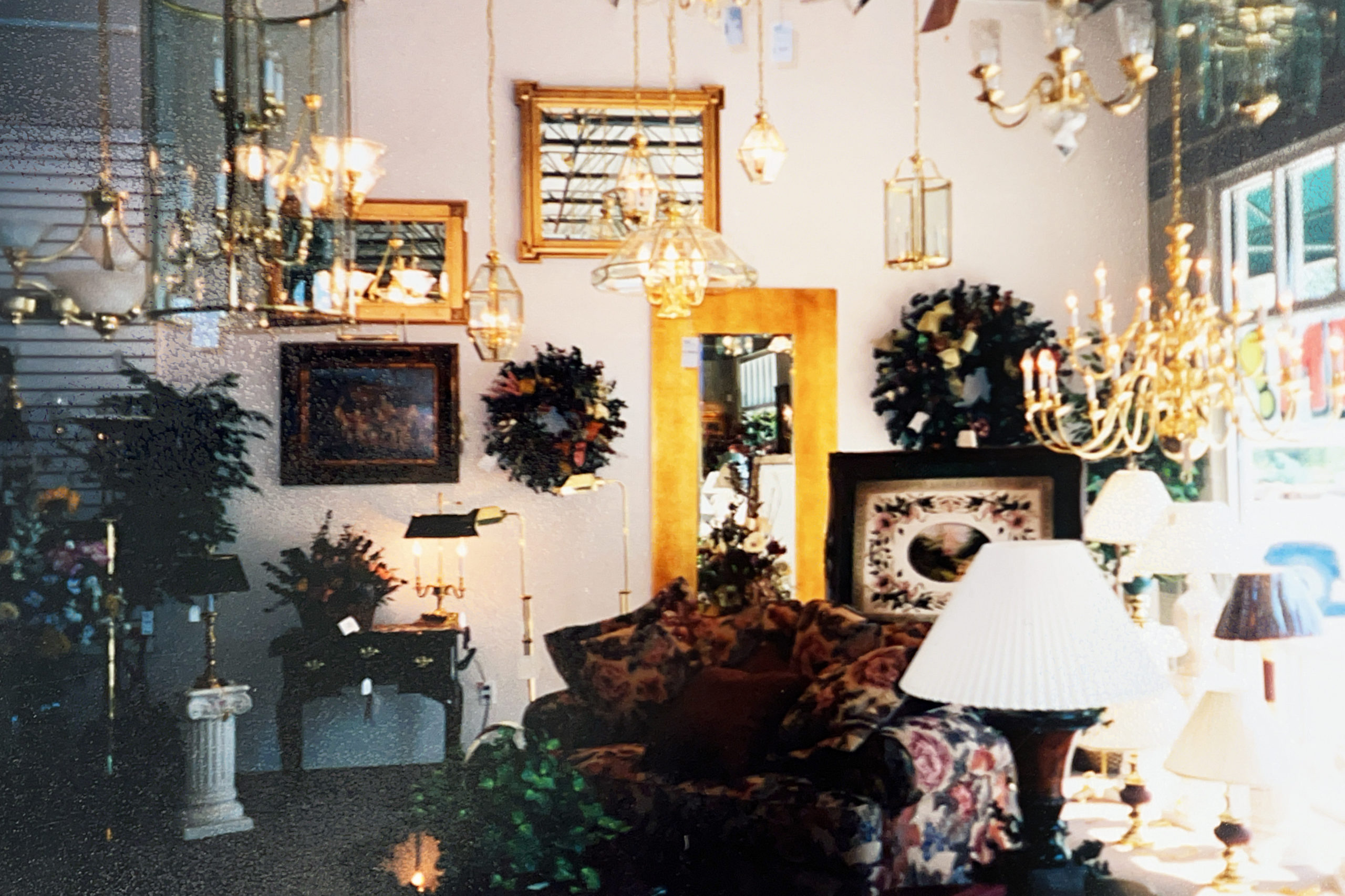 vintage photo of lighting showroom featuring chandeliers, lamps, wall lights and mirrors...