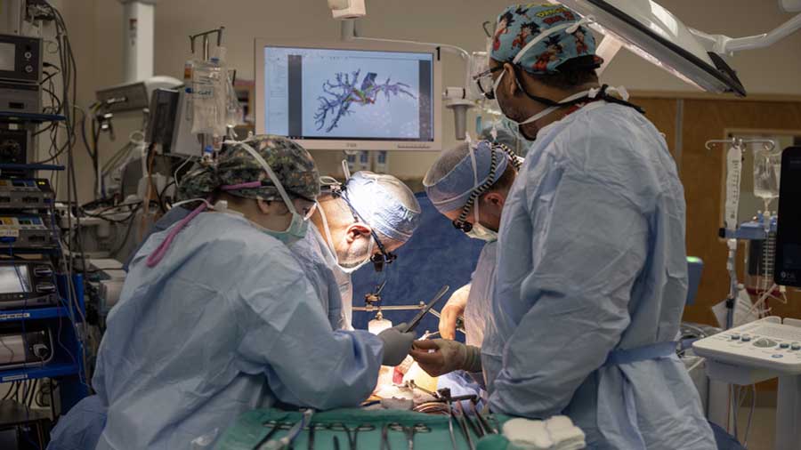 Doctors work on a liver transplant at Intermountain Health hospital...