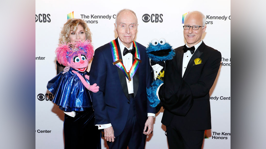 Sesame Street co-founder Lloyd Morrisett (C) with Sesame Street characters Abby Cadabby (L) and Coo...