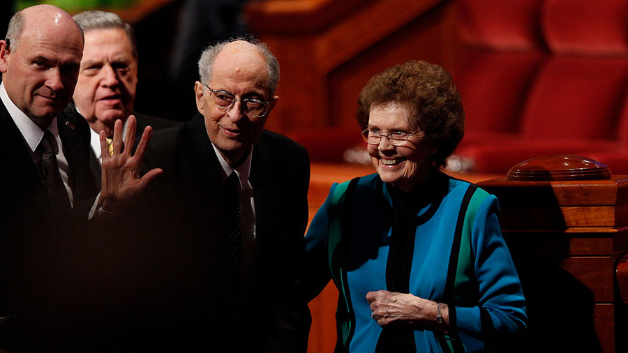 Elder Robert D. Hales leaves with his wife, Mary, from the Sunday afternoon session of general conf...