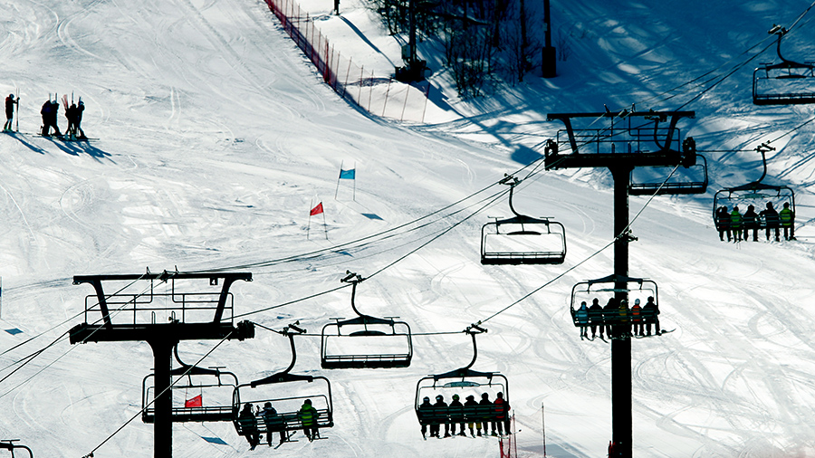ski lifts on a snow-covered slope of a mountain...