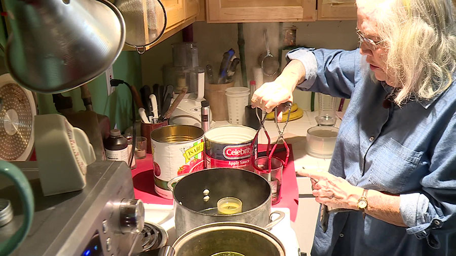 Susan Keene creating the candle stove kits with donated supplies. (KSL-TV)...