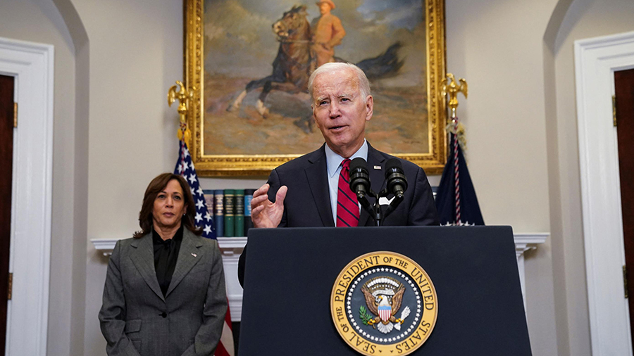 President Biden speaking at a podium...