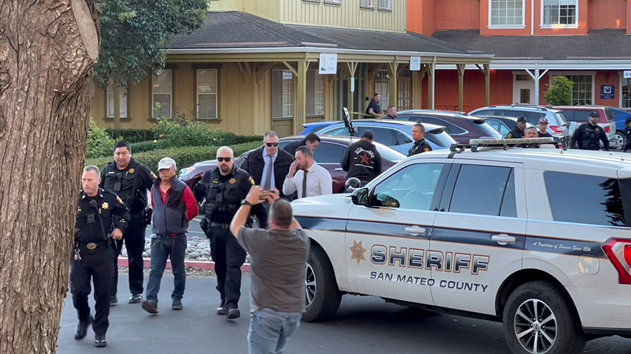 Police officers detain a man, believed by law enforcement to be the Half Moon Bay mass shooting sus...
