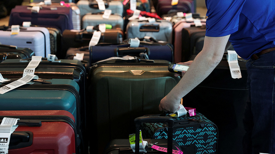 Southwest Airlines employees assist passengers in locating their luggage after U.S. airlines, led b...
