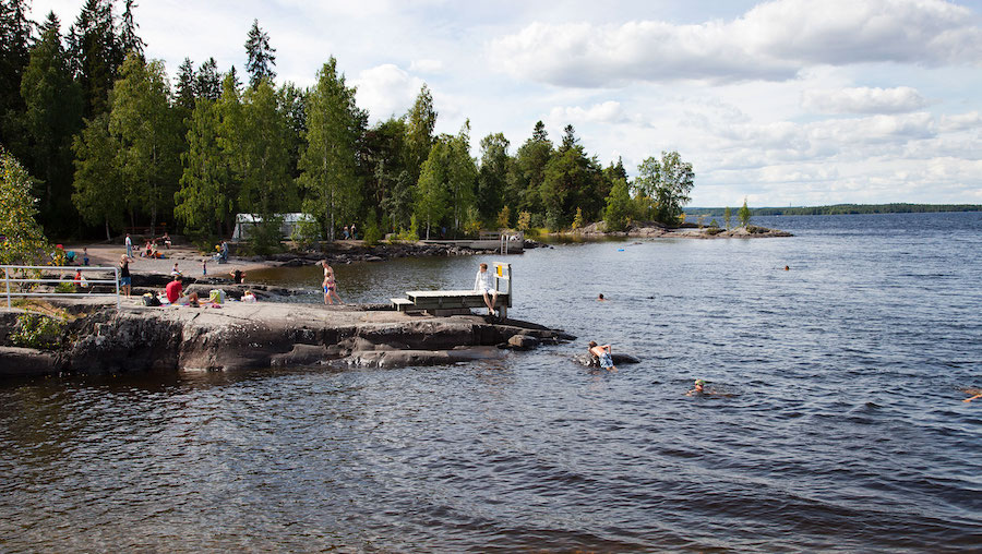 People enjoy nature at a lake in Finland. (Giulio Andreini/UCG/Getty Images via CNN)...