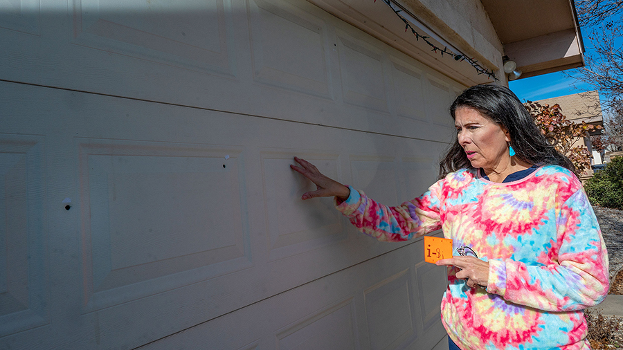 Sen. Linda Lopez , D-Albuquerque, shows bullet holes in her garage door after her Westside home was...