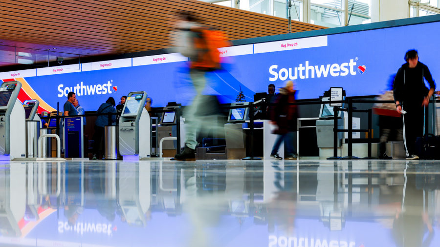 DENVER, CO - DECEMBER 28: Travelers walk past the Southwest Airlines check-in counter at Denver Int...