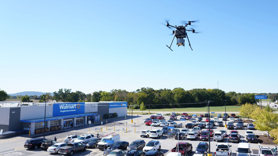 A Walmart drone is flying over a parking lot...