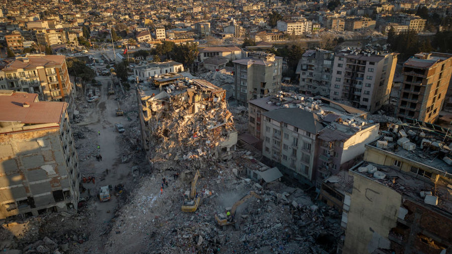 Bulldozers work to clear the rubble of destroyed buildings on February 20, 2023 in Hatay, Turkey. A...