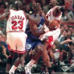 On June 7, 1998, Karl Malone drives between Dennis Rodman and Michael Jordan during game 3 of the NBA Finals. (Gary McKellar)