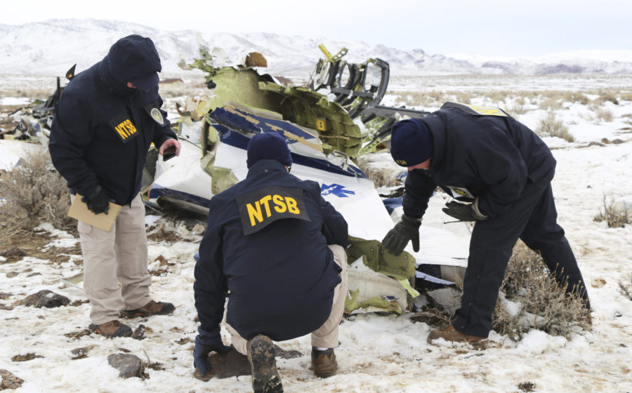 This photo provided by The National Transportation Safety Board shows NTSB investigators documentin...