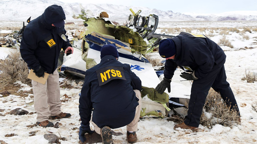NTSB investigators documenting wreckage of a Pilatus PC-12 airplane at the crash site in Dayton, NV...