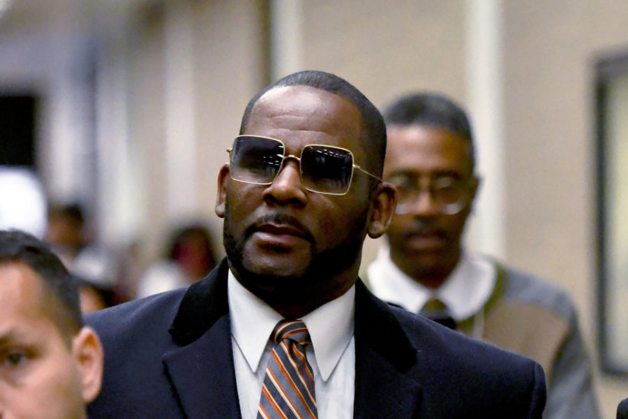 FILE - R. Kelly, center, leaves the Daley Center after a hearing in his child support case May 8, 2...
