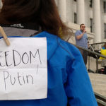 A person wearing "Freedom from Putin" sign on their back (KSLTV/Mark Less)