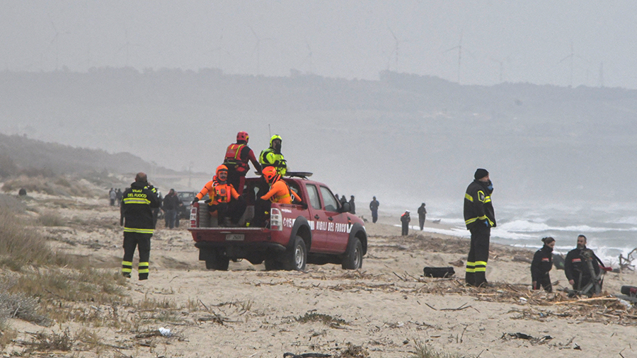 Rescuers arrive at the beach where bodies believed to be of refugees were found after a shipwreck, ...
