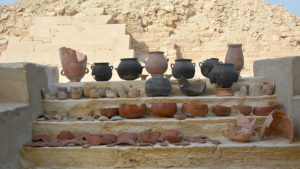 ancient Egyptian pottery aligned on ruins