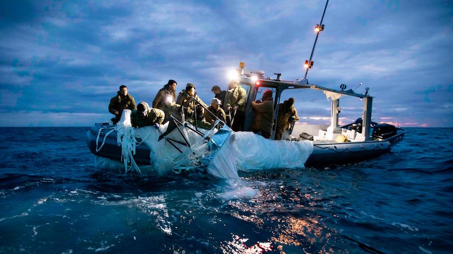 Sailors assigned to Explosive Ordnance Disposal Group 2 recover debris from a suspected Chinese sur...