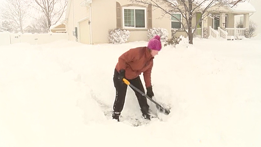 Ashley Bingham shovels snow...