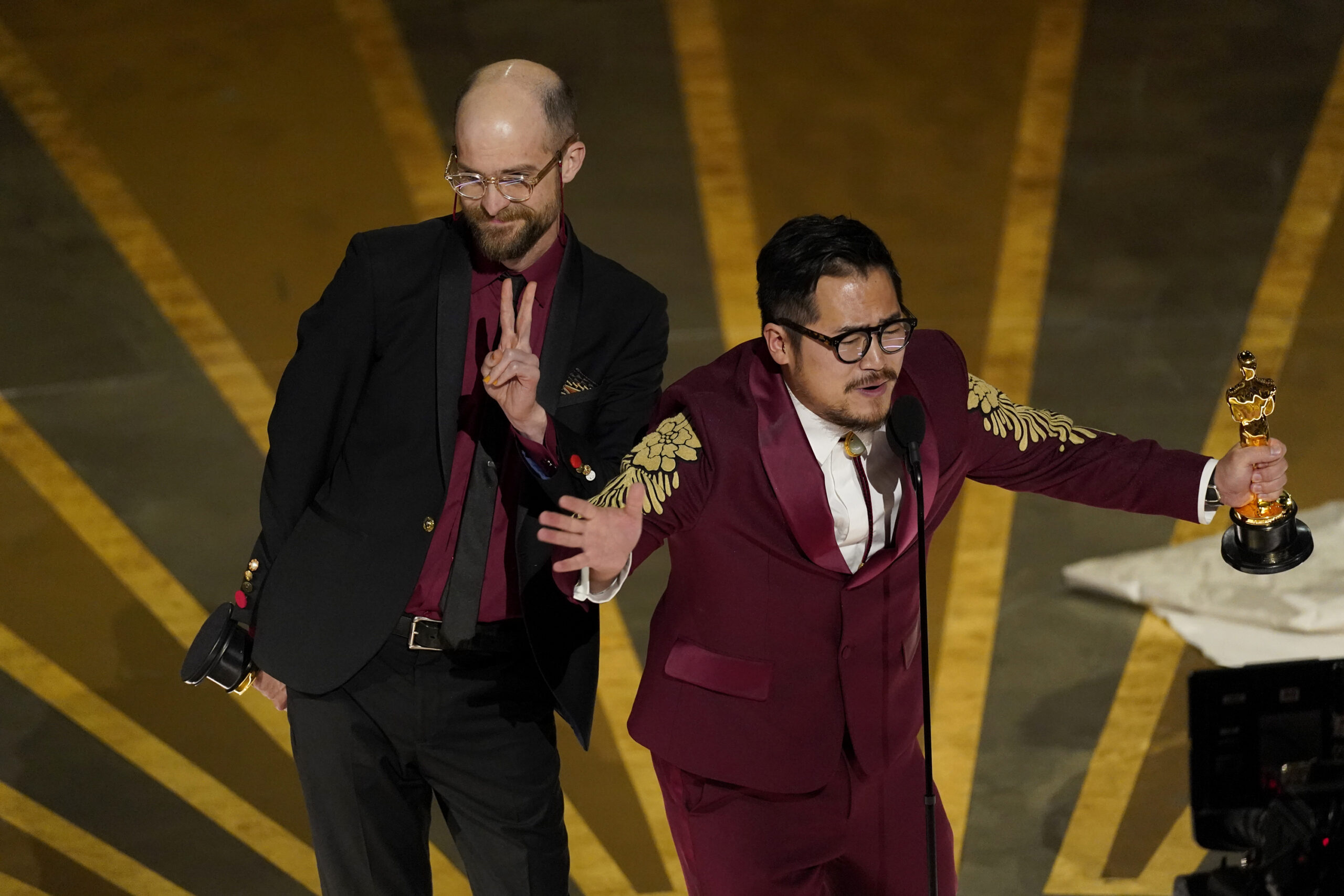 Daniel Scheinert, left, and Daniel Kwan accept the award for best original screenplay for "Everythi...