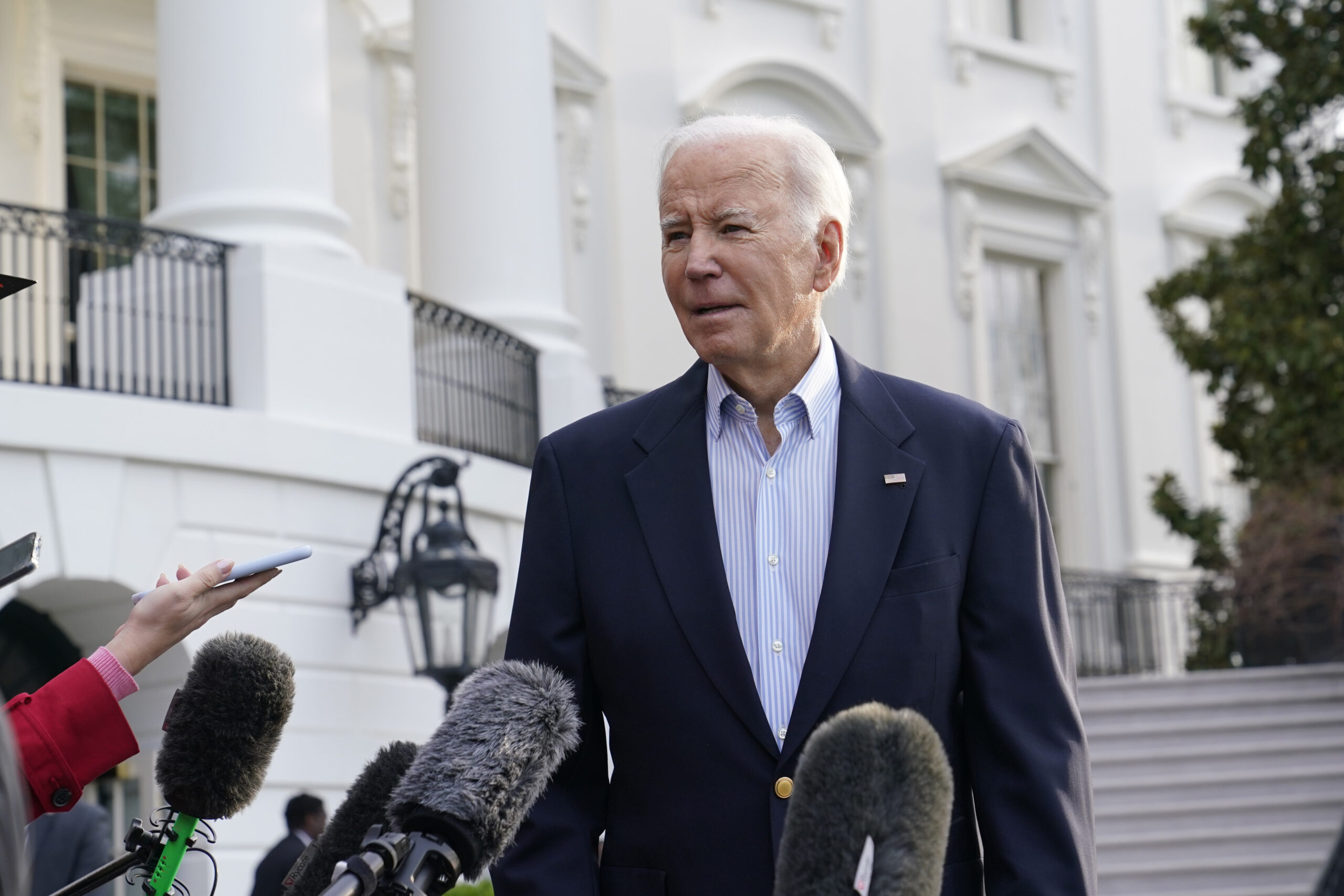 President Joe Biden talks with reporters on the South Lawn of the White House in Washington, Friday...