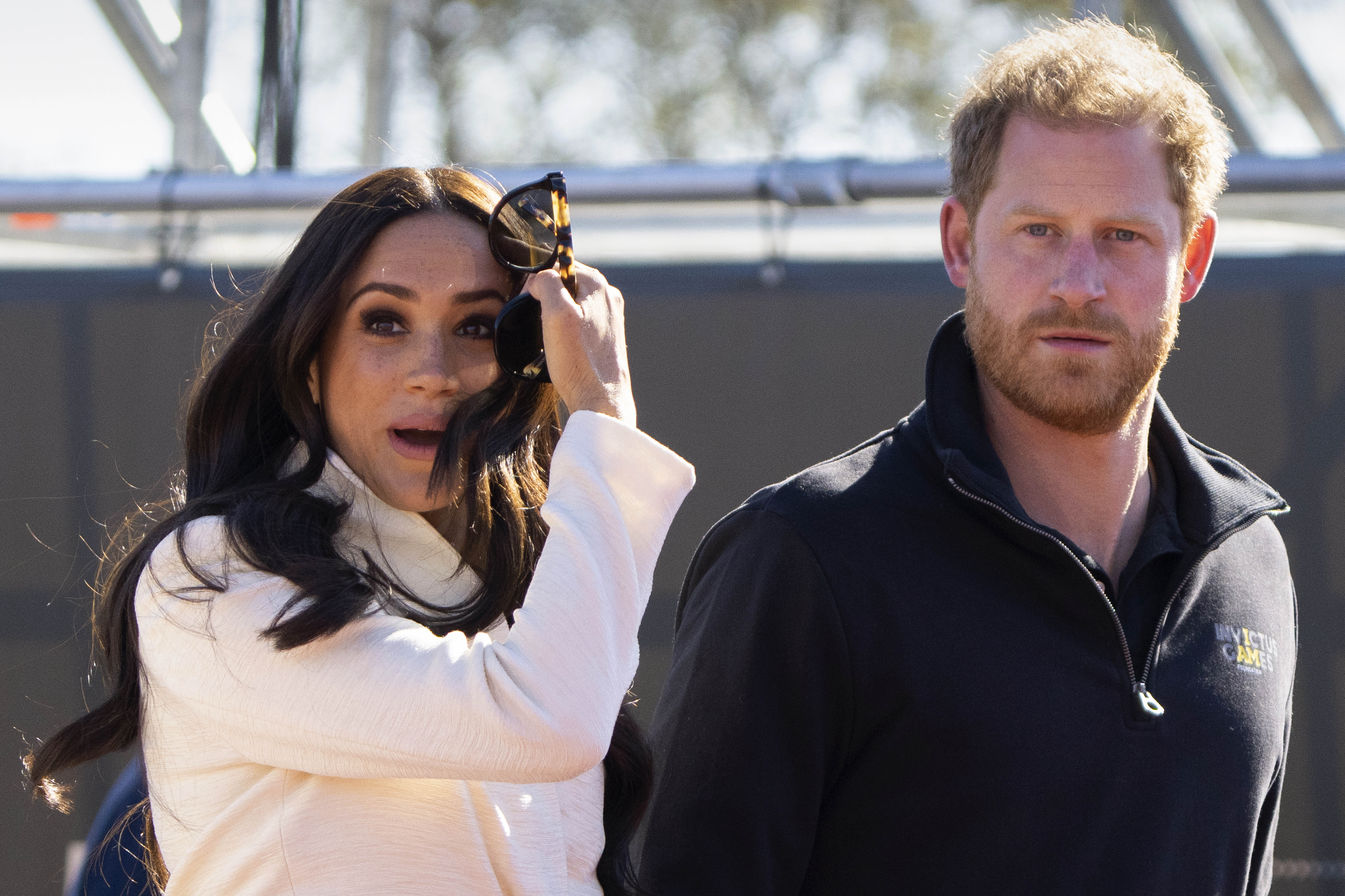 FILE - Prince Harry and Meghan Markle, Duke and Duchess of Sussex visit the track and field event a...
