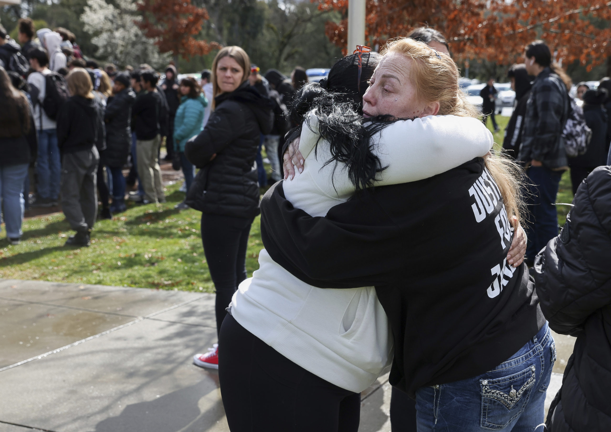 Misty Lenwell, mother of Jayden Pienta, receives a hug after speaking to students during a walkout ...