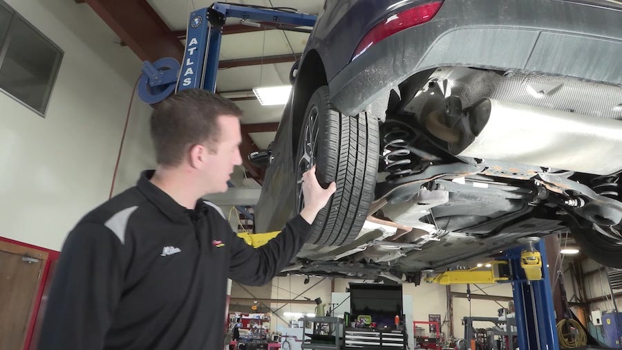 Miles Bell, manager of Dave's Auto Center in Centerville, inspects some tires. (KSL TV)...