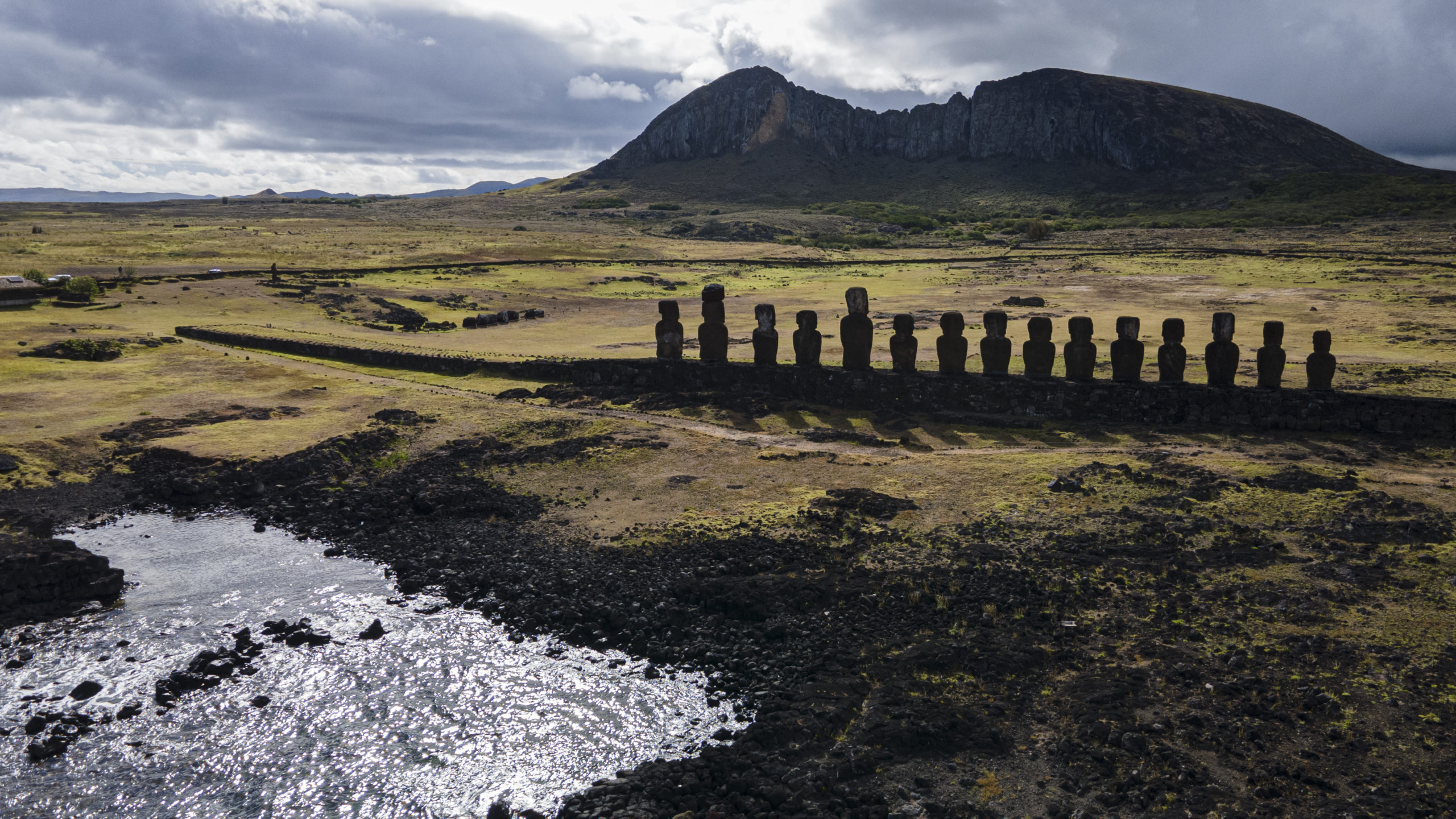 Moai statues stand on Ahu Tongariki near the Rano Raraku volcano, top, on Rapa Nui, or Easter Islan...