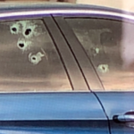 A car riddled with bullet holes in the Farmington U.S. Post Office parking lot after a report of shots fired there on Wednesday, March 1, 2023. (KSL TV)