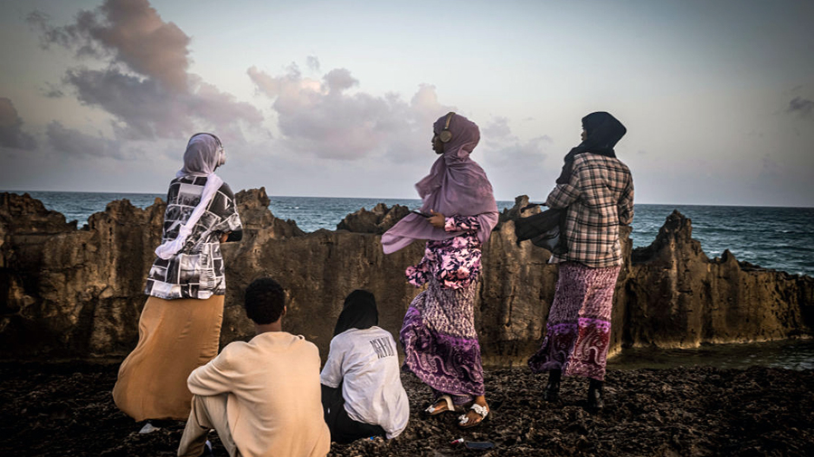 MOGADISHU, SOMALIA - SEPTEMBER 4: Young women and men explore a secured beach area near the runway ...