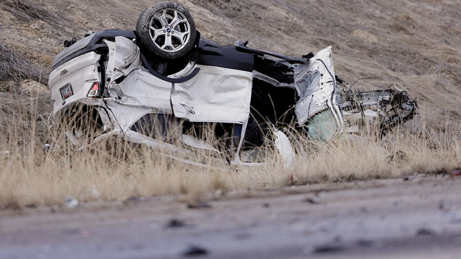 One of two cars involved in a crash sits upside down as Utah Highway Patrol and Salt Lake City Poli...