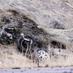 A car engine sits in a burned area of grass on the berm of I-215 as Utah Highway Patrol and Salt Lake City Police investigate following a collision between two cars at 700 North just off of I-215 in Salt Lake City on Friday, March 3, 2023. (Deseret News	/Scott G Winterton),
