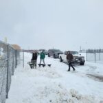 Players, parents, and coaches spent Sunday  by scooping and moving the snow off the softball field. (Lisa Hall)