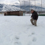 Dave Swenson walking around the deep snow in the baseball field. (Mike Anderson/KSL TV)