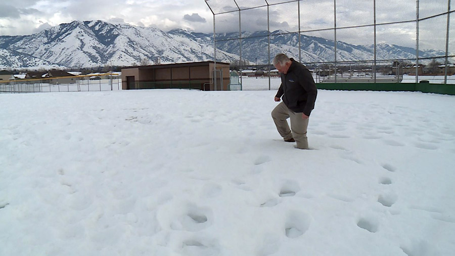 Dave Swenson walking around the deep snow in the baseball field. (Mike Anderson/KSL TV)...