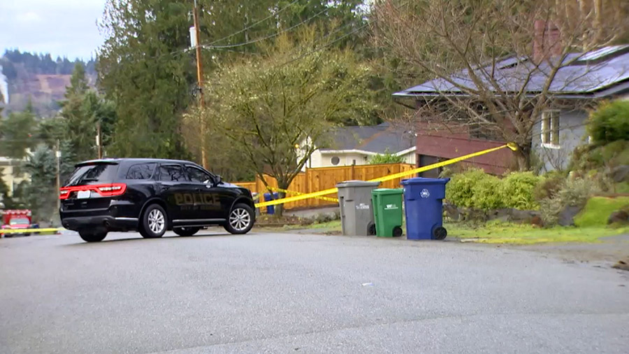 Authorities cordon off the scene of a fatal shooting in Redmond, Washington, on Friday. A husband a...