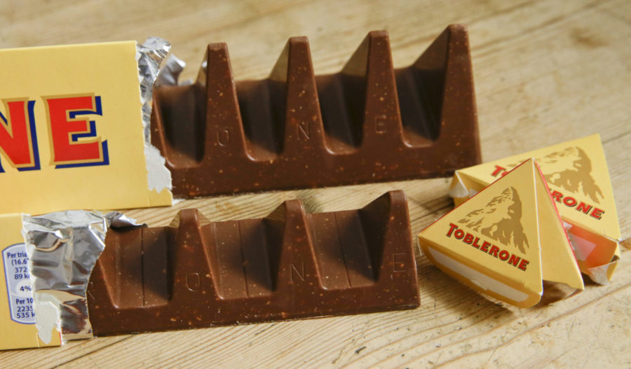 Two bars of the Toblerone Swiss chocolate are shown, at front is the new style 150 gram bar showing...
