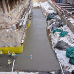 A concrete slab is laid around the perimeter of the temple to create a clean and level working surface during the multiyear renovation of the temple in Salt Lake City, Utah, March 2023. (Intellectual Reserve, Inc.)