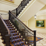 The grand staircase in the Richmond Virginia Temple is reflective of colonial design and constructed of Peruvian walnut with vibrant colors of the era incorporated in the stair's carpet runner. (Intellectual Reserve, Inc.)