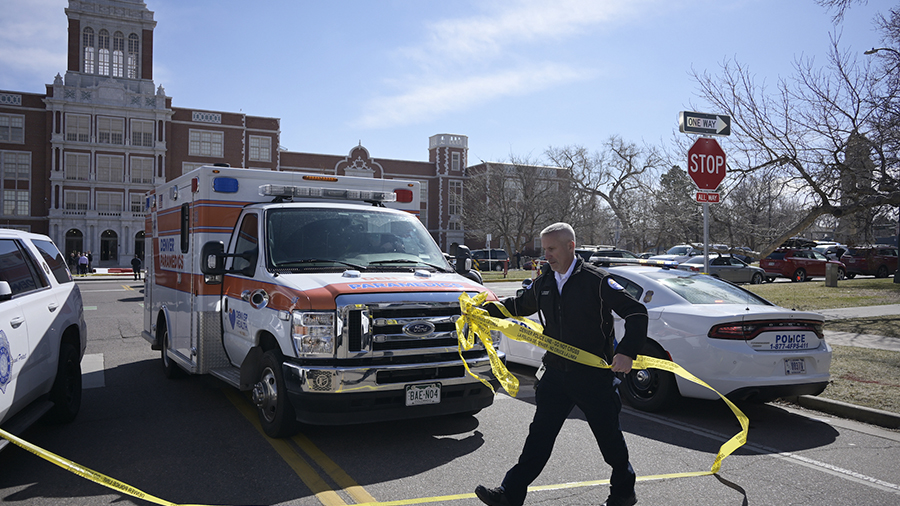 Police investigate at Denver's East High School after a shooting there on Wednesday, March 22, 2023...