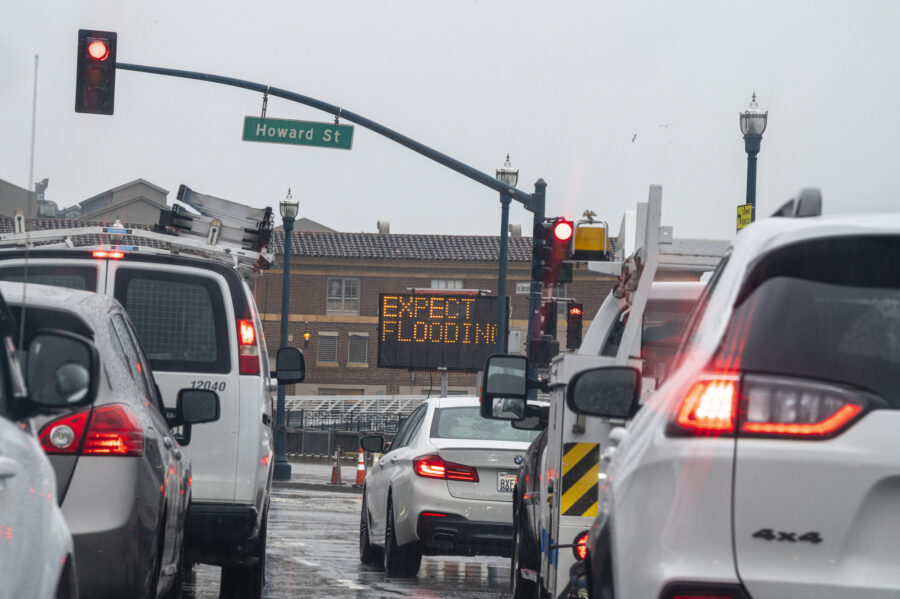 An "Expect Flooding" sign on the Embarcadero during a rain storm in San Francisco, California, US, ...