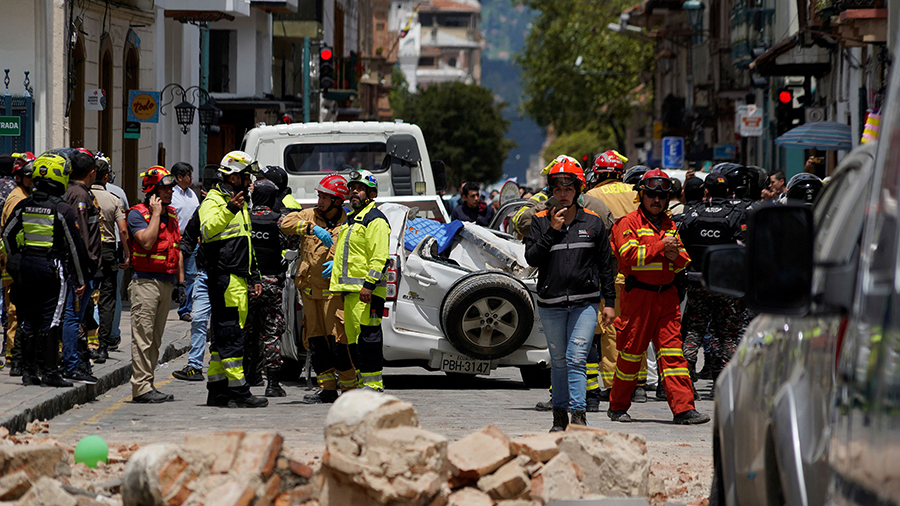 A damaged car and rubble from a house affected by the earthquake are pictured in Cuenca, Ecuador. (...