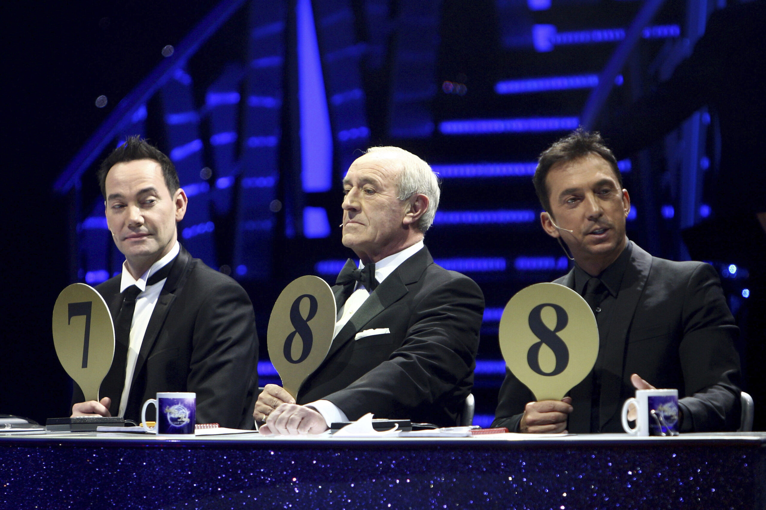FILE - From left, judges Craig Revel Horwood, Len Goodman and Bruno Tonioli gesture, during the fin...