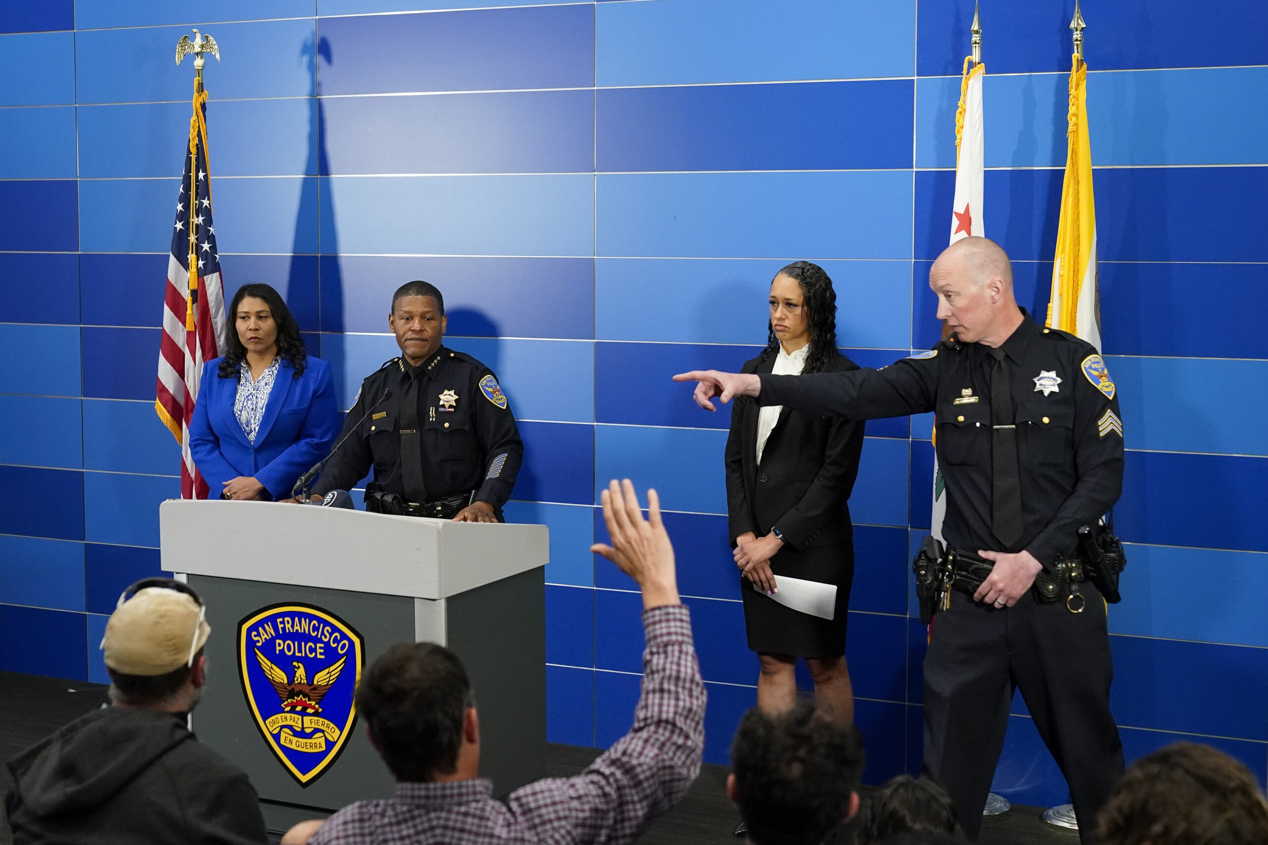 San Francisco Police Chief William Scott, second from left, answers questions from reporters during...