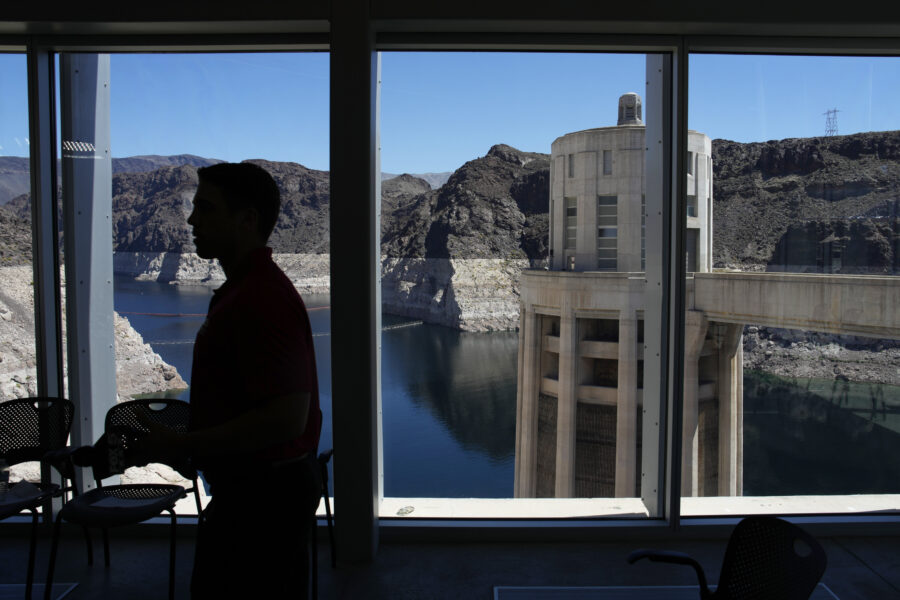 People attend a news conference on Lake Mead at Hoover Dam, Tuesday, April 11, 2023, near Boulder C...